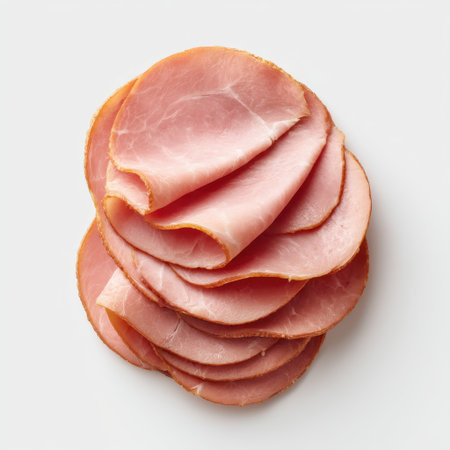 Sliced pink ham displays a savory texture and culinary potential, making it perfect for sandwiches, recipes, and gourmet dining experiences. Ideal for food photography.の素材
