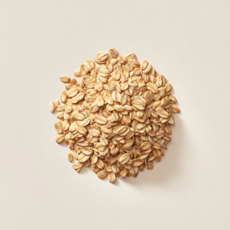 A vibrant close-up of fresh organic oats in a neat pile on a soft neutral background, perfect for illustrating nutritious meal options and wholesome ingredients.の素材
