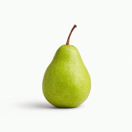 A vibrant green pear stands alone on a white background, highlighting its smooth texture and unique shape. Perfect for promoting healthy eating or culinary uses.の素材