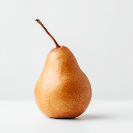 A single pear elegantly positioned on a plain white background, emphasizing its smooth texture and unique shape. Perfect for healthy food themes and culinary projects.の素材