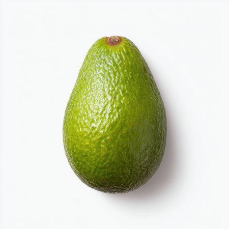 A single ripe avocado with a smooth green exterior, set against a clean white background, perfect for promoting healthy eating and culinary creativity.の素材