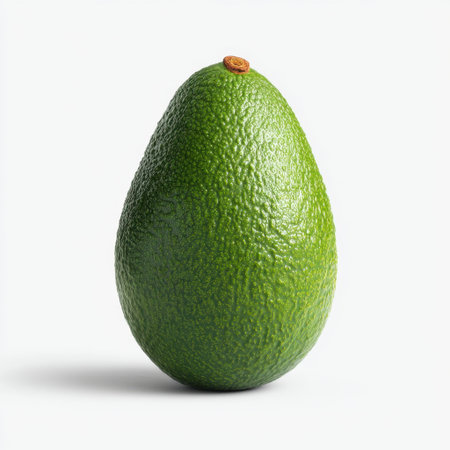 This high-quality image features a fresh green avocado against a clean white background, showcasing its smooth and textured skin, perfect for culinary use.の素材