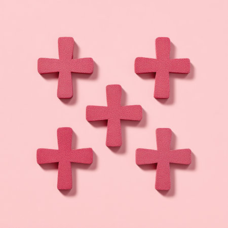 This image features five pink foam crosses arranged on a soft pink background. Ideal for craft projects or decorative displays, it enhances any creative setting.の素材