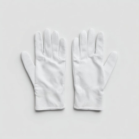 This image features a pair of white gloves placed neatly on a light background, ideal for showcasing hygiene, elegance, or professional usage in various settings.の素材