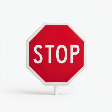 A striking bright red stop sign featuring bold white letters, perfect for illustrating traffic safety concepts and road signage in various urban and rural environments.の素材