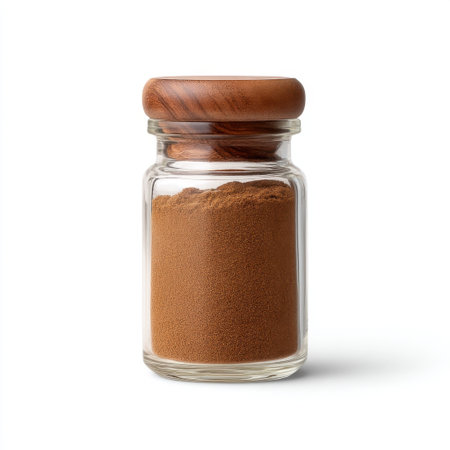A transparent glass jar filled with fine brown powder, featuring a stylish wooden lid. This image highlights the beauty of ingredients in kitchen settings, perfect for culinary inspiration.の素材