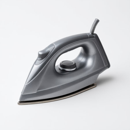 This modern steam iron in a sleek gray design features an ergonomic handle and efficient performance, perfect for wrinkle removal and garment care at home.の素材