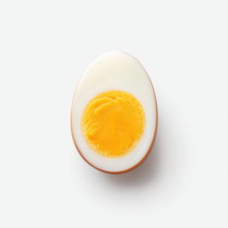 This image showcases a perfectly halved boiled egg, highlighting the smooth texture of the white shell and bright yellow yolk, ideal for food photography and culinary inspiration.の素材