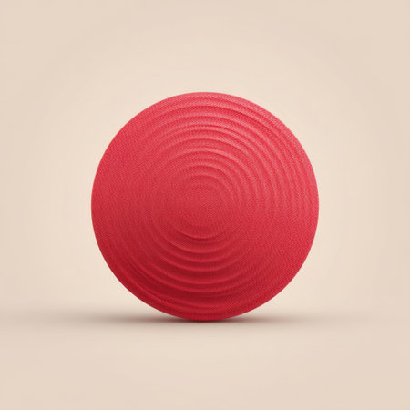 A vibrant red circular object featuring a textured surface, set against a soft neutral background. Ideal for design projects, branding, and visual arts.の素材