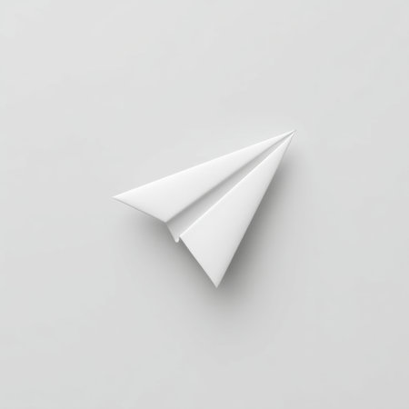This clean and minimalistic image features a white paper airplane on a plain background, representing concepts of freedom, creativity, and innovation in various contexts.の素材