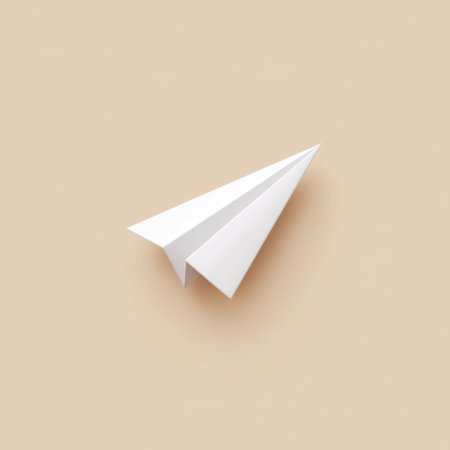 A minimalist paper airplane rests on a soft beige background, symbolizing creativity and freedom. Ideal for design projects, educational themes, or inspirational concepts.の素材