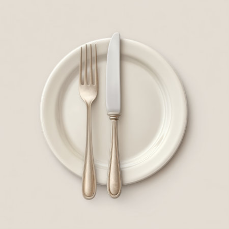 This image showcases an elegant dining arrangement with a fork and knife placed neatly on a pristine white plate, perfect for stylish meal presentations.の素材