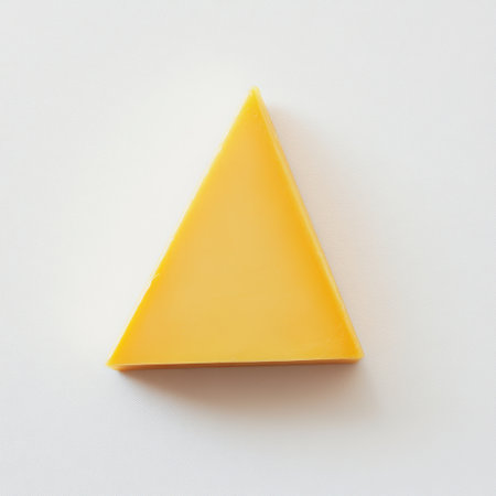 A vibrant triangular slice of yellow cheese sits against a clean white backdrop, perfect for showcasing culinary delights and enhancing food presentations.の素材