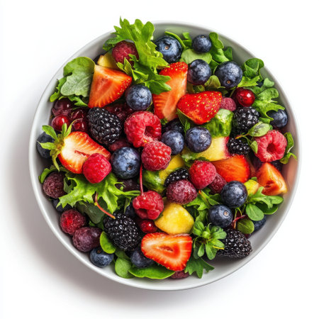 A vibrant bowl filled with fresh berries and leafy greens, ideal for healthy eating. Perfect for summer meals and colorful presentations on any dining table.の素材