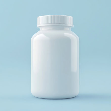 A pristine white pill bottle sits against a soft blue background, perfect for health and wellness themes. Ideal for pharmaceutical and nutritional designs.の素材