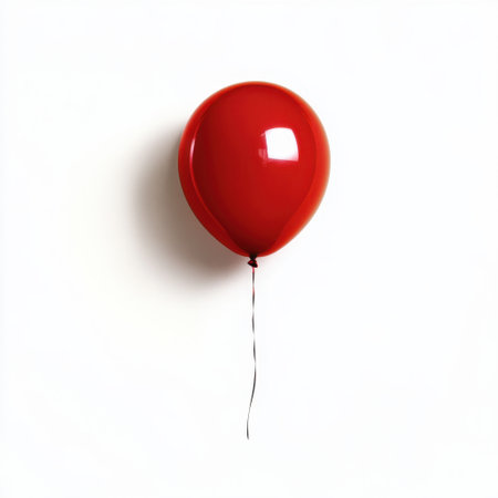 A singular bright red balloon floats gracefully against a pristine white background, symbolizing joyful celebrations and festive occasions for various events.の素材