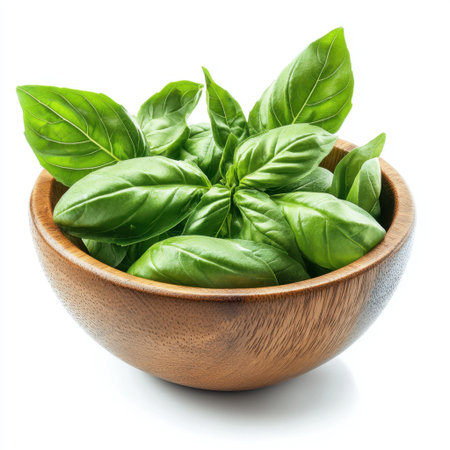 Fresh green basil leaves displayed in a wooden bowl, perfect for enhancing the flavor of various dishes and ideal for healthy culinary creations and Mediterranean meals.の素材
