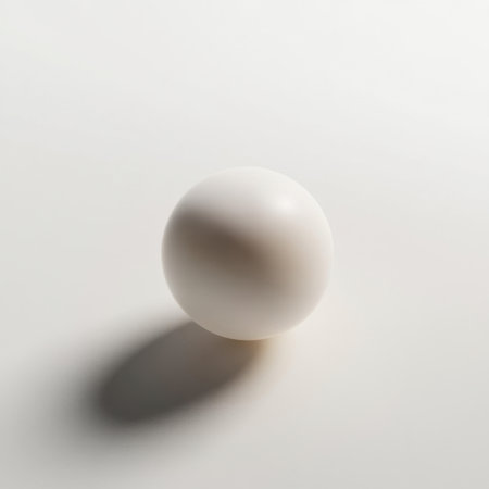 A smooth white sphere sits on a minimalist surface, casting a soft shadow. This abstract composition evokes elegance and simplicity, perfect for modern design projects.の素材
