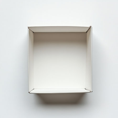 This image features an empty square cardboard box viewed from above on a clean white surface. Perfect for showcasing packaging or design concepts.の素材