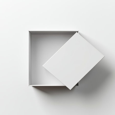 A clean and minimalist image showcasing an empty white box with an open lid on a simple surface, ideal for packaging or presentation in modern settings.の素材