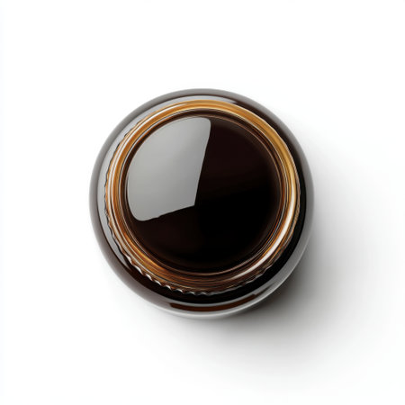 This close-up image captures the intricate details of a dark glossy surface within a round container, showcasing reflections and smooth contours perfect for artistic projects.の素材