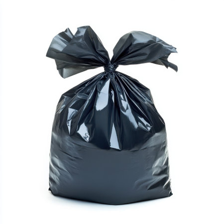 A detailed image of a black garbage bag tied securely, ideal for depicting waste disposal practices, household cleanup efforts, and urban sanitation solutions.の素材