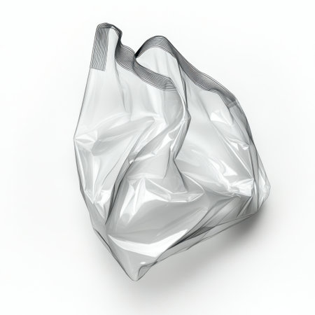 A crumpled transparent plastic bag rests on a white background, showcasing its textured surface. This image emphasizes themes of environmental impact and recycling awareness.の素材