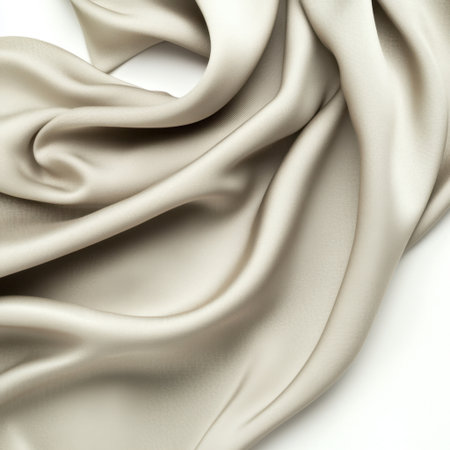 Discover the beauty of a smooth beige satin cloth, featuring elegant drapery accents that add sophistication, ideal for fashion and interior design projects.の素材