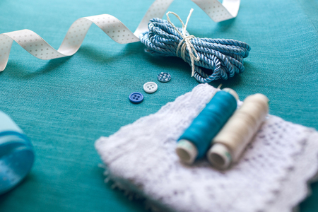 still life of spools of thread / Spool of thread isolated on blueの写真素材