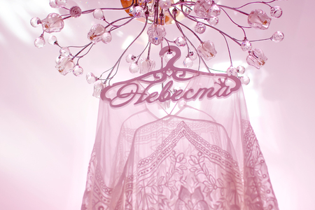 wedding dress hanging from a mirrored wardrobeの写真素材