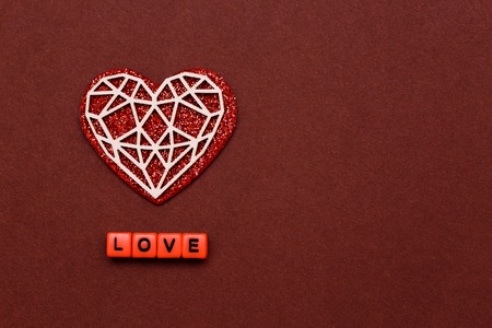 February 14. Valentines Day. Red white heart on a red background next to love letters. The concept...