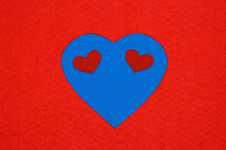 February 14. Valentines Day. Heart of blue on a red background. Smileの写真素材