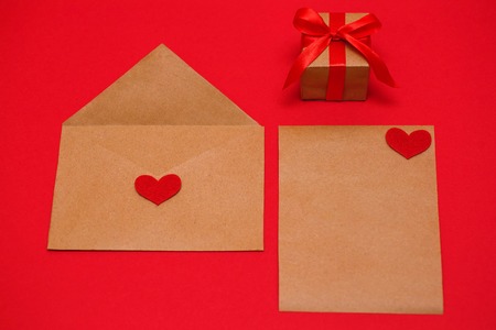Valentines Day. The 14th of February. An envelope, a sheet of paper and a gift, ready to be sent to your loved one.の写真素材