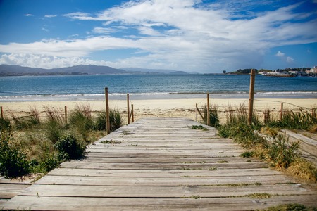 wooden bridge overlooking the ocean, beautiful view, sunny Spainの写真素材