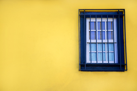 Colorful yellow house with blue shutters and window. In Porto, Portugalの写真素材