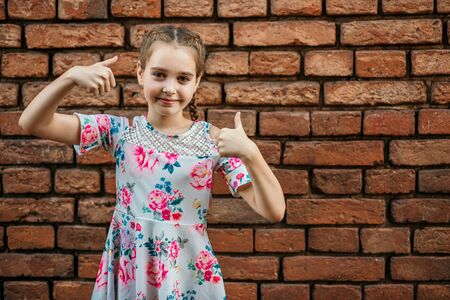 beautiful teenager girl showing thumbs upの写真素材