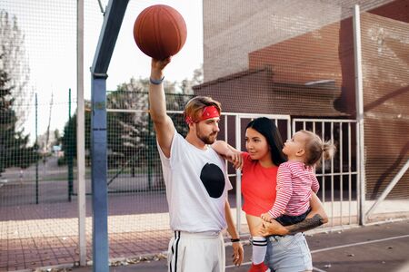 sports family plays basketball, mom, dad and daughterの写真素材