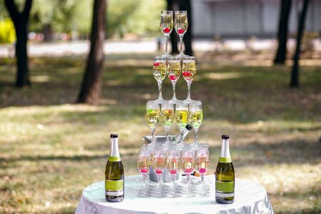 champagne glasses pyramid at summer party, stand outdoorsの写真素材