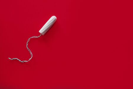 Medical female swab on a red background, top viewの写真素材
