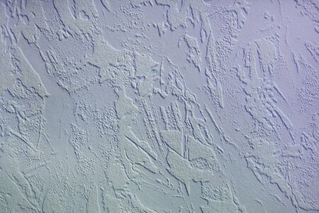 Stucco white wall, background from patterns on the wall, uniform textureの写真素材