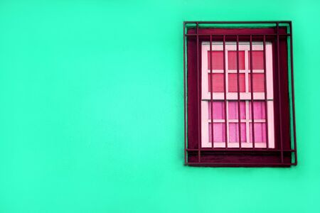 Colorful green house with a purple window, Porto, Portugal, green wall of a beautiful house, unusual architecture, bright colors, interesting colors, window grilleの写真素材