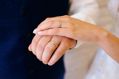 hand of the bride and groom close-up, wedding rings, horizontal photo, close-upの写真素材
