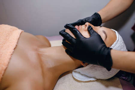 Facial massage. Spa skin and body care. Facial beauty care, place for textの写真素材