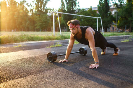 Male athlete doing push-ups outdoors, bodyweight athlete trainingの写真素材