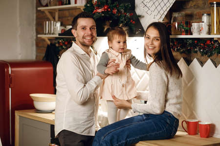 Young family spend time in the kitchen, christmas party or new year