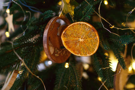 Christmas and New Year holidays. The tree is decorated with garlands and lights. A slice of dry...