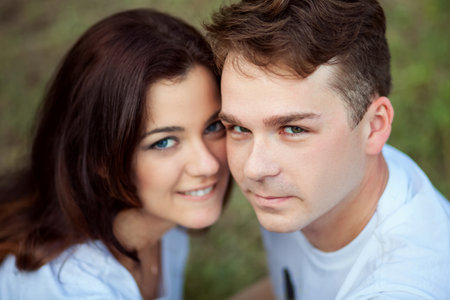 Portrait of a man and a woman huddled togetherの写真素材