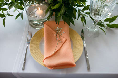 Served table in the restaurant. The cafe hall is waiting for guests for a festive dinner. The plate...