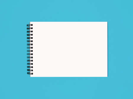 Notebook made of white paper with binding on a blue background. Empty notepad without notes with...