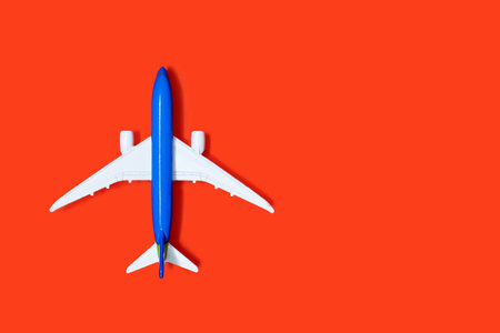 Aircraft model on an orange background with free space for text or advertising. The concept of...